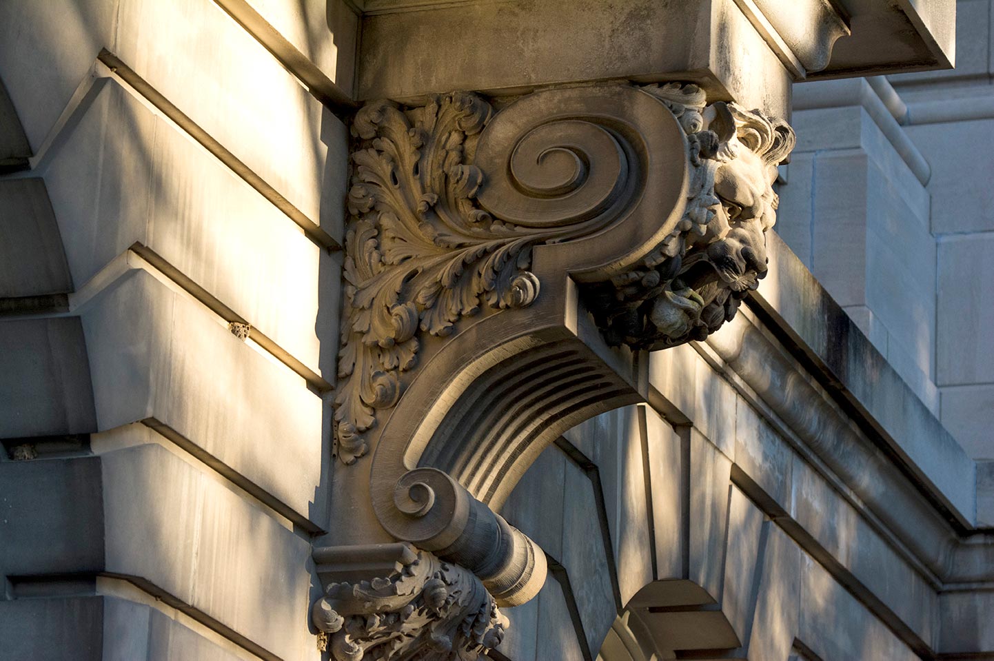 Detail view of stone leaf scrolls on the Guerin Hall facade