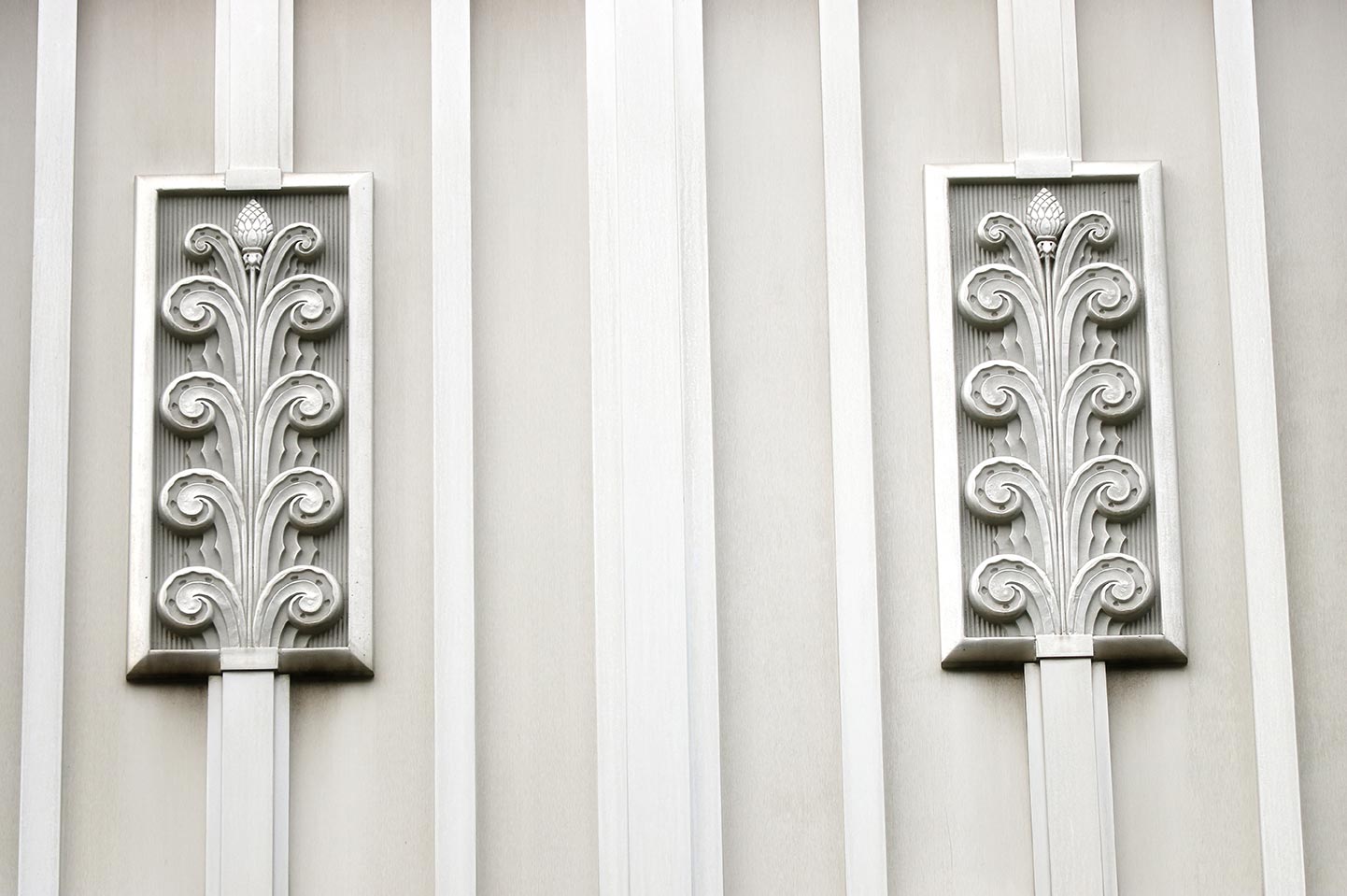 Closeup of the simple floral decoration on the exterior of Owens Hall