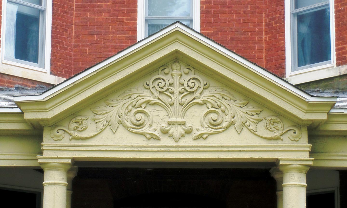 Detail view of the ornate woodwork above the entryway